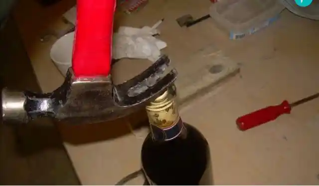 Opening a bottle of wine with a nail and a hammer