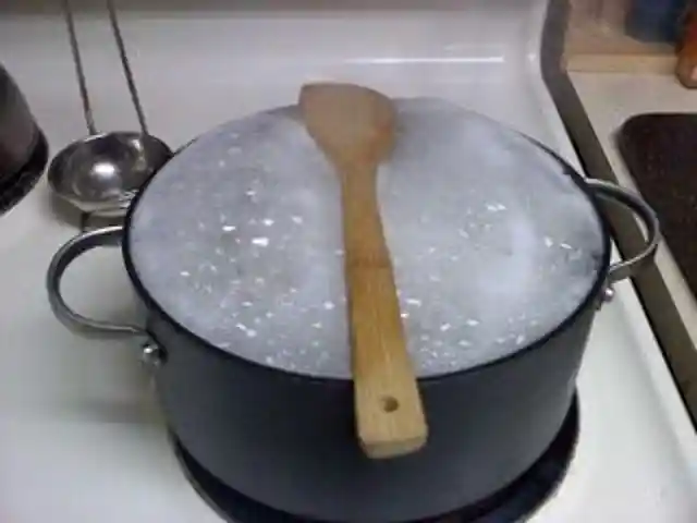 Keep a wooden spoon on top of a boiling pot of water