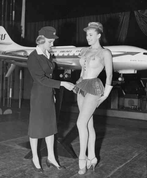 A Scandinavian Stewardess examines a new uniform proposal for Scandinavian Airlines in 1958, strangely enough it wasn't approved